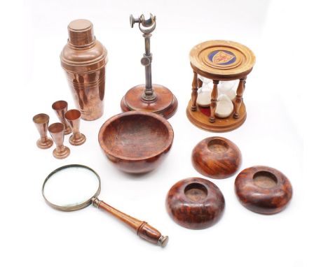 A small mixed lot to include; a magnifying glass on metal and wooden stand, a wooden cased triple egg timer with shield desig