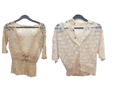 A cream lace blouse with a low neckline and short sleeves, peplum waistline with a pink ribbon threaded through inbuilt waist