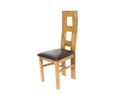 A set of four heavy oak ladder back dining chairs, with leather upholstered seats