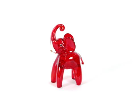 A Murano red glass figure of an elephant, with trunk raised aloft, 18cm high