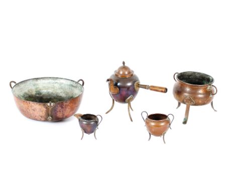 An Arts &amp; Crafts design copper three handled bowl; a copper cauldron shaped bowl; and a three piece Arts &amp; Crafts des