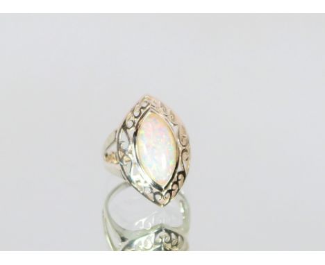 A white metal and opal coloured dress ring, with pierced decoration