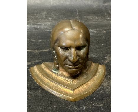 A bronze mascot in the form of a native American.