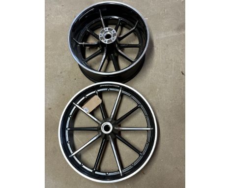 A pair of Harley Davidson wheels, appear either brand new or recently restored.