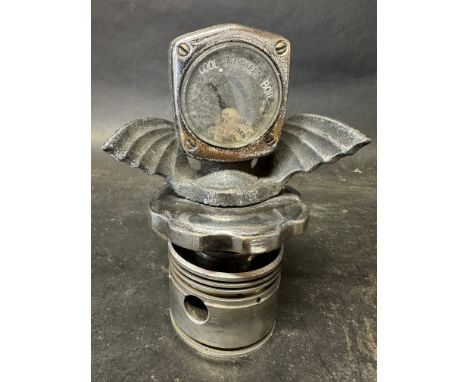 A Wilmot Breedon car radiator gauge, with wings, by repute in working condition, sat upon a piston for presentation purposes.