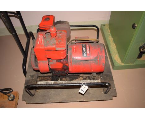 Homelite alternator generator, with petrol engine mounted on wooden board on casters.