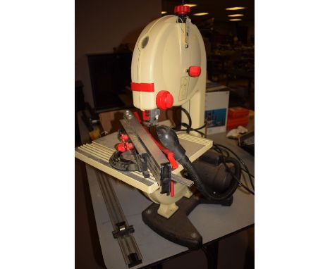 A Jet model JW9BS-9 9in. bandsaw with light, and spare blades, etc.