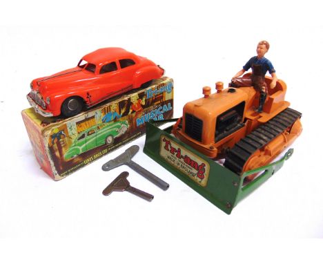 A TRI-ANG COLLECTION  comprising a No.2 Minic Musical Car, red, boxed; Minic bulldozer, orange (blade detached), unboxed; and