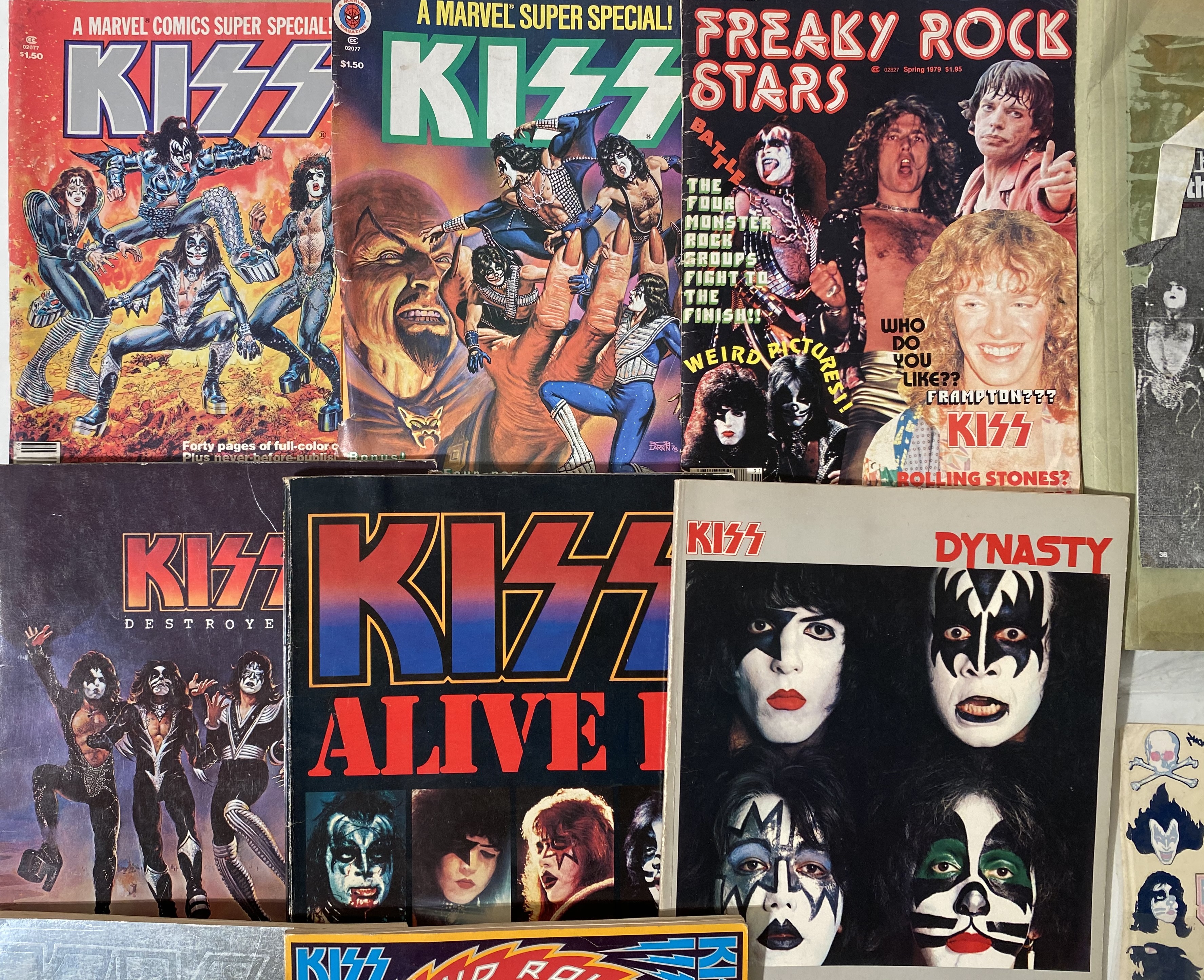 KISS MEMORABILIA. 27 items to include 4 official Aucoin red enamel