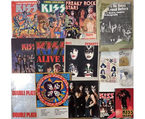 KISS MEMORABILIA. 27 items to include 4 official Aucoin red enamel necklaces, 6 Kiss guitar picks, 2 guitar strings, a guitar