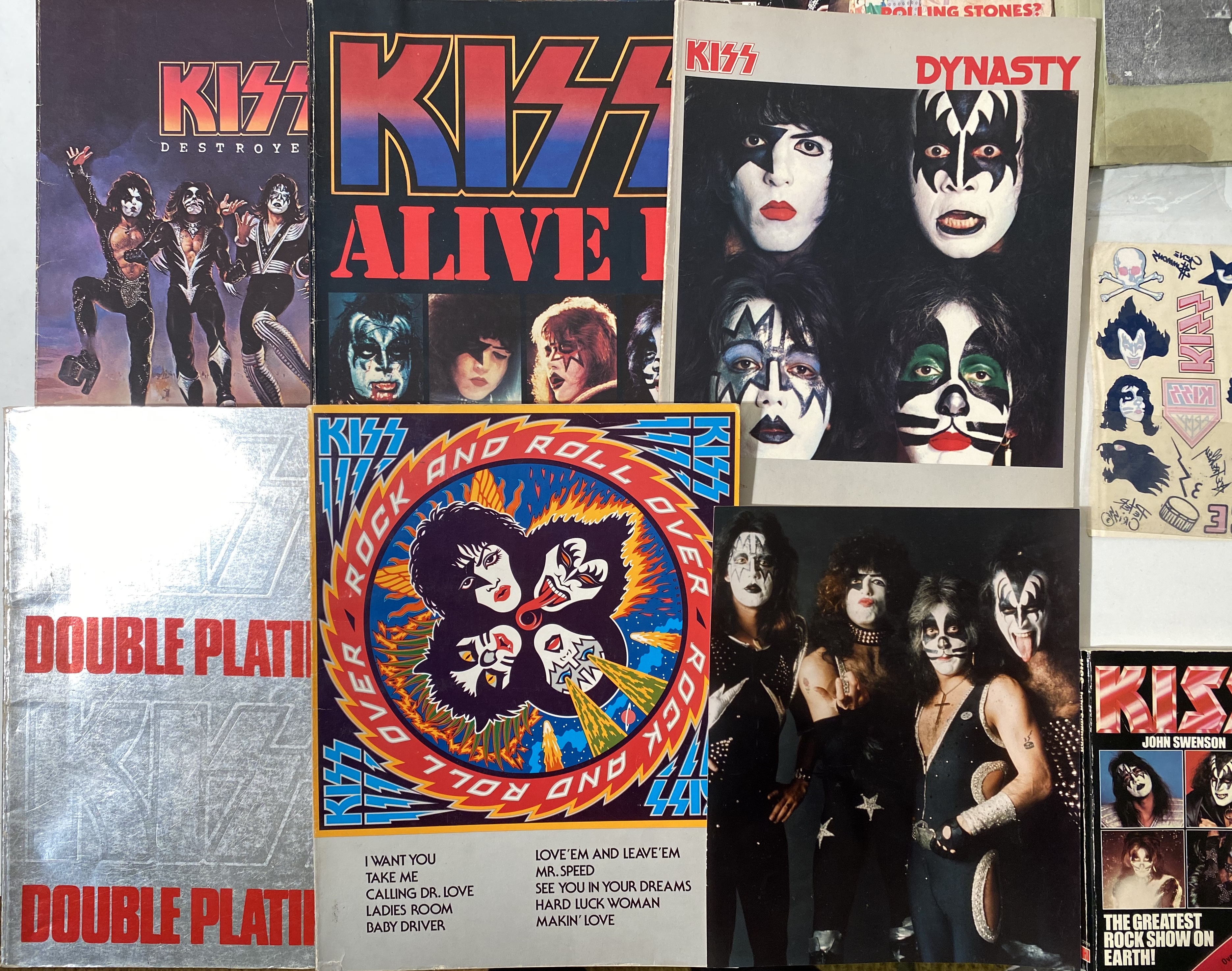 KISS MEMORABILIA. 27 items to include 4 official Aucoin red enamel ...