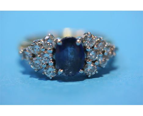 An 18ct gold diamond and sapphire cluster ring.