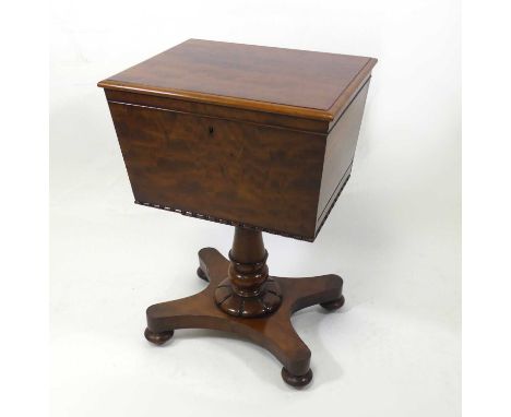 A William IV mahogany pedestal teapoy, the hinged cover opening to reveal a well-fitted interior with centre zinc liner, the 