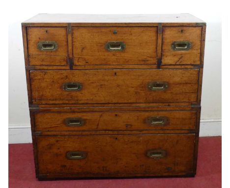 A Victorian mahogany and brass bound secretaire campaign chest, in two sections, the upper section having three short drawers