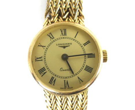 A 9ct yellow gold lady's Longines quartz wristwatch, having a round champagne Roman dial and integral woven mesh style bracel