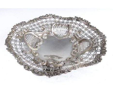 A Victorian silver table basket, of pierced shaped oval form, decorated with floral scrolls and geometric pierced edges, stan