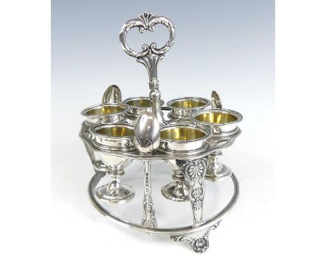 A George IV silver six-cup egg cruet, the shaped ring suspension tier supported by three palm-leaf cast supports to a ring pl
