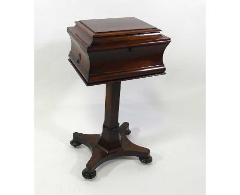 A Regency rosewood pedestal teapoy, of sarcophagus form, the removable caddy having unfitted interior, raised on a quatraform