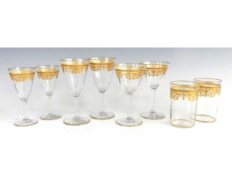 An early 20th century continental part suite of glassware, possibly by Moser, each with gilt and beaded white enamel decorati