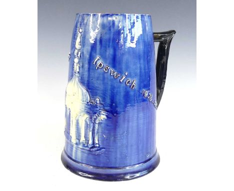 A Castle Hedingham blue glazed pottery tankard, circa 1890, commemorating Ye Market Cross Ipswich, pad mark and signed Edward