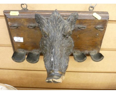 Carved boar's head pipe rack