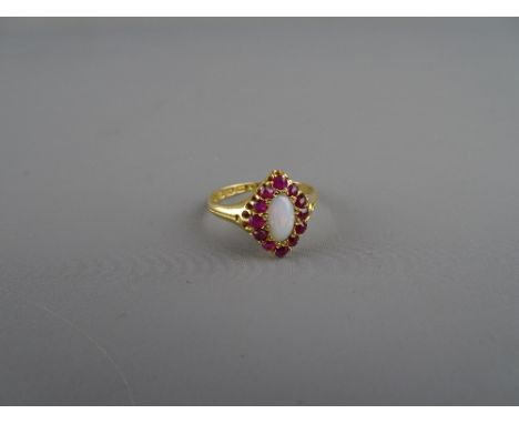 Eighteen carat gold dress ring with oval white opal and twelve surrounding rubies, 3.3 grms, size 'P'