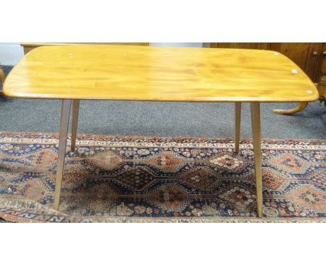 An Ercol 382 pattern blonde plank  dining table, tapering outswept legs, blue label