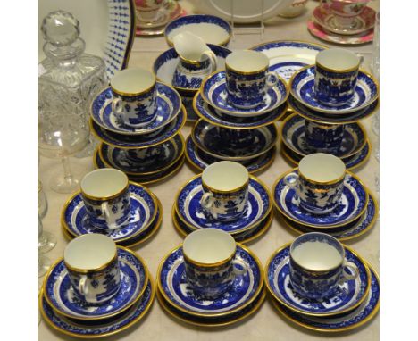 A Victorian Staffordshire willow pattern part tea service comprising of 12 side plates, 12 saucers, cream jug, two bread and 
