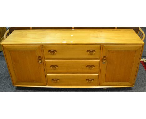 An Ercol  455 design blonde Windsor sideboard, rounded rectangular surface, three short drawers, flanked by two cupboard door