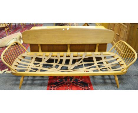 An Ercol blonde day bed/ studio couch (lacking seat) pebble shaped back rest, blue label