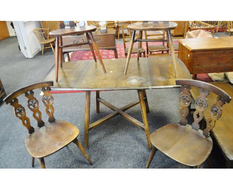 An Ercol 375 pattern fleur de lys set of four dining chairs; an Ercol 387 pattern drop leaf dining table, X Frame, stretcher,