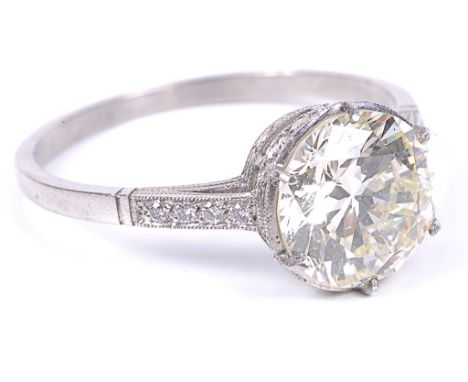 A Platinum Diamond Solitaire Ring:The old brilliant cut diamond spreading at over 2.5ct, with diamond set shoulders and diamo