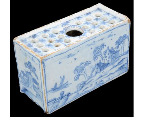 An English Delftware Pottery Brick, Circa 1750:Finely painted with 13 holes to the top, 7.5 cm x 12 cm x 5 cm.  Provenance: B