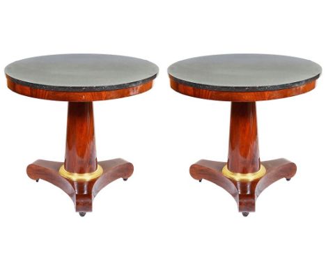 A Pair of Empire Period Circular Marble-Topped Tables:Black marble topped circular tables with ormolu fittings to the tapered
