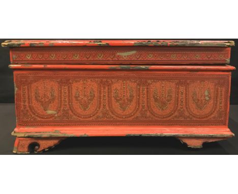 A Persian red lacquered rectangular box and cover, decorated with arched panels and foliate scrolls, bracket feet, 53cm wide 