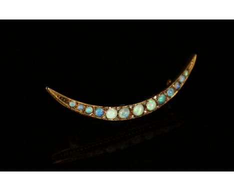 An Edwardian 9ct gold and opal crescent bar brooch, the 13 graduated cabochon stones divided by small diamonds, 4.8cm x 1.5cm