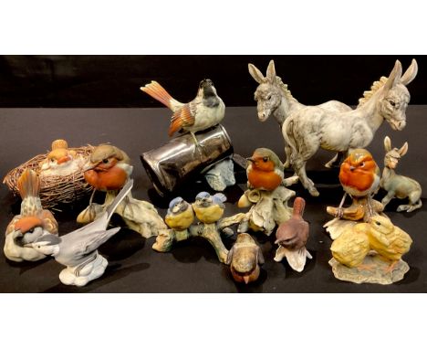 An Italian Capo-di-Monte model of a bird on a tin can, 15cm, painted Naples mark in blue; other similar Italian bird models; 