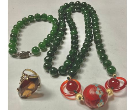 A jadeite and agate beaded necklace; a jadeite beaded bracelet; a 9ct gold smoky quartz ring, the large navette shaped stone 