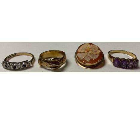 A 9ct gold four stone amethyst ring, R/S, 2.3g; a 9ct gold buckle ring, size N, 4.5g; a 9ct gold sapphire and white stone rin