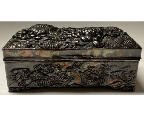 A late 19th/early 20th century Japanese pewter jewellery box, cast with foaming waves and birds in flight in relief, the cove