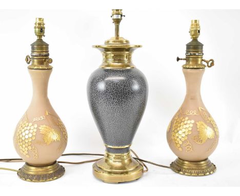 A pair of glass table lamp bases decorated in gilt with grapes and vine leaves, height 49cm, with another lamp base, height 5