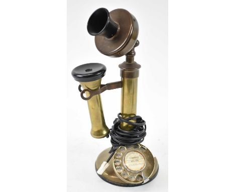A vintage brass candlestick telephone, height approx 34cm.