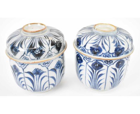 A pair of Chinese blue and white pots with covers (af).Condition Report: One cover has slight damage comprising chips and lig