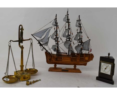 A small set of brass scales with weights, a desk barometer/thermometer/hygrometer, and a small wooden model of HMS Bounty (3)