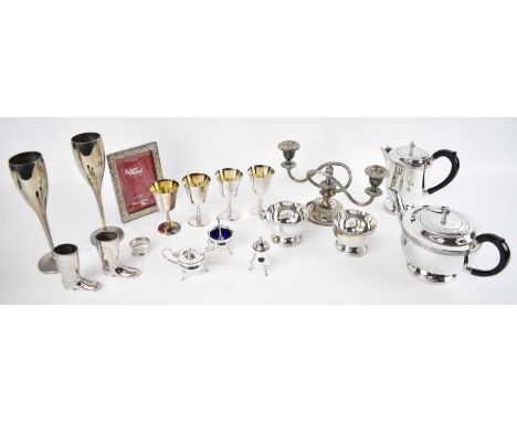 A four piece silver plated tea service, four silver plated goblets, candlestick, a three piece cruet, etc.