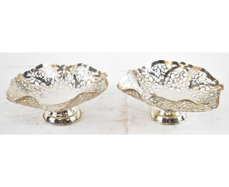 ARNOLD &amp; SONS; a pair of Elizabeth II hallmarked silver pierced shaped hexagonal bonbon dishes, London 1962, diameter 13.