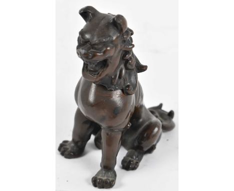 A Chinese bronzed metal figure of a Dog of Fo, seal mark to base, height 12.5cm.