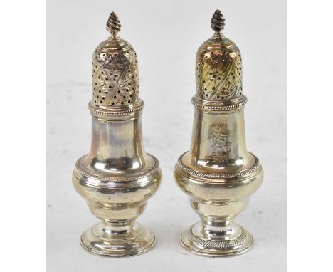 A near pair of George III hallmarked silver sugar casters, one by Jabez Daniell and James Mince, the other by John Delemester