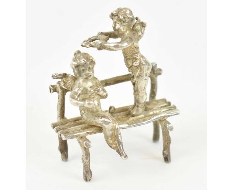 A late Victorian hallmarked silver miniature model of two cherubs on a bench, with import marks for London 1899, approx. 28.5