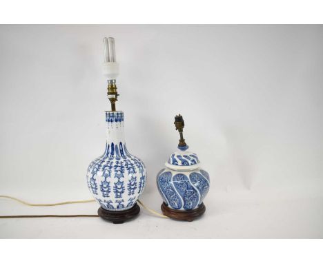 A Chinese style blue and white baluster form lamp base, height 34cm, with another blue and white lamp (2).